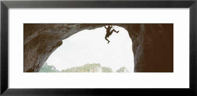 Silhouette Of A Man Climbing A Rock, Railay Beach, Krabi, Thailand by Panoramic Images Pricing Limited Edition Print image