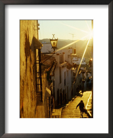 Woman Climbing Stairs In Old Street, Antequera, Spain by Wayne Walton Pricing Limited Edition Print image