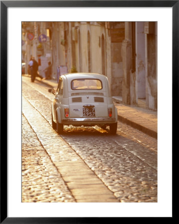 Fiat 500 Driving Down Cobbled Street, Noto, Sicily, Italy by John Miller Pricing Limited Edition Print image