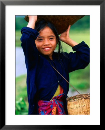 Portrait Of Girl Balancing Basket Of Herbs, Muang Ngoy, Laos by Anthony Plummer Pricing Limited Edition Print image
