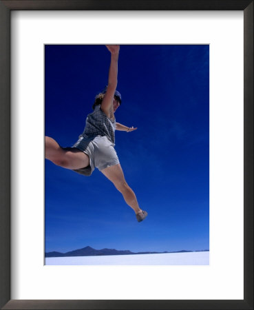 Woman Jumping On Salt Pan, Salar De Uyuni, Bolivia by Woods Wheatcroft Pricing Limited Edition Print image