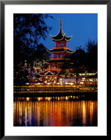 Colored Lamps Outlining The Pagoda At Tivoli Are Reflected In The Water by Sisse Brimberg Pricing Limited Edition Print image