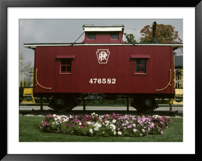 A Bright Red Caboose And A Flower Bed Compete For Vivid Color by Stephen St. John Pricing Limited Edition Print image