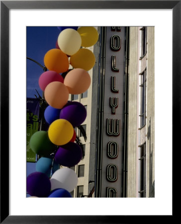 Multi-Colored Balloons And A Neon Sign Welcome Visitors To Hollywood by Stephen St. John Pricing Limited Edition Print image