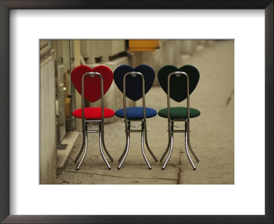 A Trio Of Fashionable Chairs With Heart-Shaped Backs On A Sidewalk by Raul Touzon Pricing Limited Edition Print image