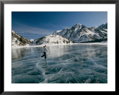 A Girl Ice Skates Across A Frozen Mountain Lake by Michael S. Quinton Pricing Limited Edition Print image