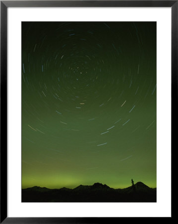 A Time-Exposure Shows The Path Of The Stars And The Northern Lights by Paul Nicklen Pricing Limited Edition Print image