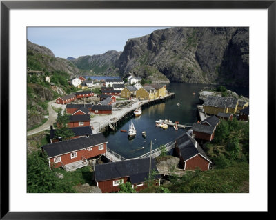 Wooden Red Houses On Stilts Over Water At The Fishing Village Of Nusfjord, Lofoten Islands, Norway by Tony Waltham Pricing Limited Edition Print image