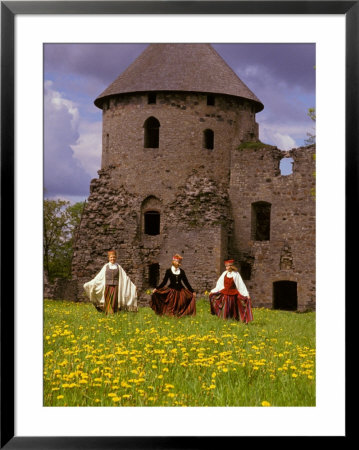 Traditionally Dressed Girls Walk Through Dandelions, Cesis Castle, Latvia by Janis Miglavs Pricing Limited Edition Print image
