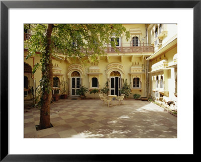 Table And Chairs In The Courtyard Of A Yellow Building by Jason Edwards Pricing Limited Edition Print image