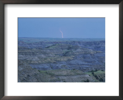 A Bolt Of Lightning Is Seen Behind A Badlands Panorama by Michael Melford Pricing Limited Edition Print image