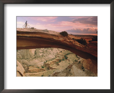 Mountain-Biking Over A Natural Arch by Kate Thompson Pricing Limited Edition Print image