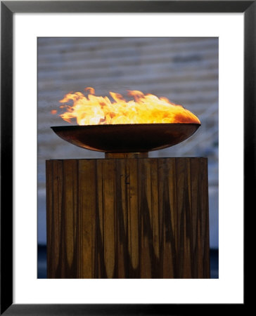 The Olympic Flame Burns In The Reconstructed Roman Stadium, Athens, Attica, Greece by Neil Setchfield Pricing Limited Edition Print image