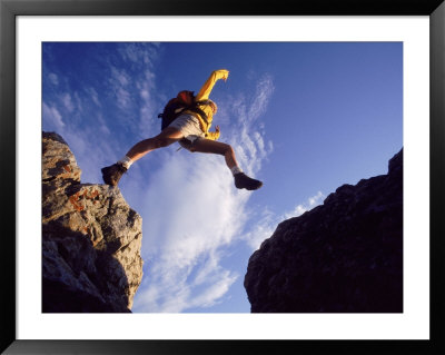 Backpacker Jumping To Rocks, Park City, Ut by Cheyenne Rouse Pricing Limited Edition Print image