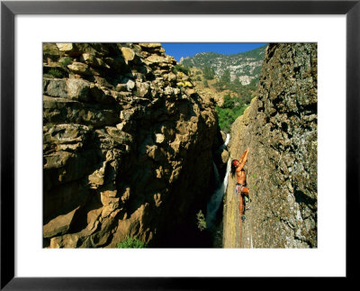 A Mountain Climber Navigates Through The Hi-Rise, Jagged Rock Formations by Barry Tessman Pricing Limited Edition Print image
