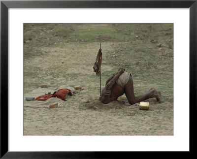 A Sadhu, Or Holy Man, Buries His Head In A Feat Of Breath Control Demonstrating His Mastery Of Yoga by George F. Mobley Pricing Limited Edition Print image