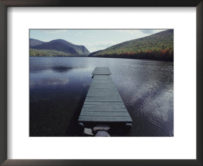 A Small Dock Leads Out To Placid Waters Of A Mountain Lake by Bill Curtsinger Pricing Limited Edition Print image