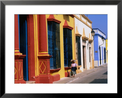 Woman Walking Past Colourful House Facades On Street, Campeche, Mexico by John Elk Iii Pricing Limited Edition Print image