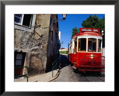 Tram Travelling Through Alfama, Central Lisbon, Lisbon, Portugal by Damien Simonis Pricing Limited Edition Print image