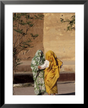 Veiled Muslim Women Talking At Base Of City Walls, Morocco by John & Lisa Merrill Pricing Limited Edition Print image