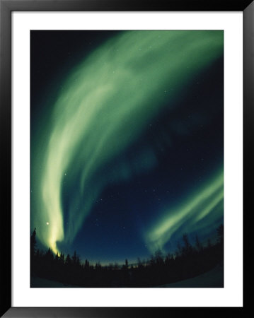 The Aurora Borealis Creates Fantastic Swirls Of Light In The Northern Sky by Paul Nicklen Pricing Limited Edition Print image