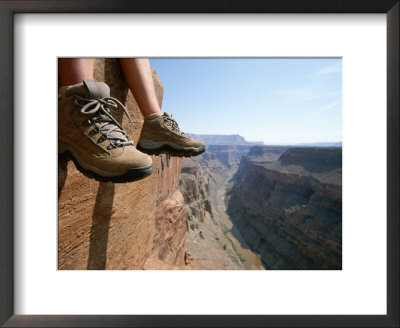 The Boot-Shod Feet Of A Hiker Dangle Over The Side Of A Cliff by John Burcham Pricing Limited Edition Print image