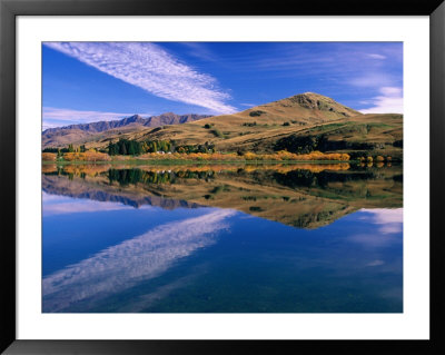 Hilly Countryside And Sky Mirrored In Lake Hayes, Near Arrowtown, Queenstown, Otago, New Zealand by David Wall Pricing Limited Edition Print image