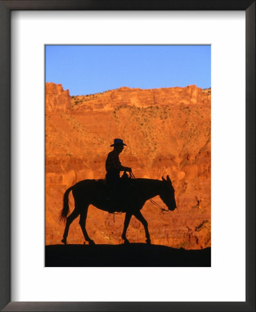 Cowboy On Mule Silhouetted Against Sandstone Cliff, Moab, Utah, Usa by Curtis Martin Pricing Limited Edition Print image