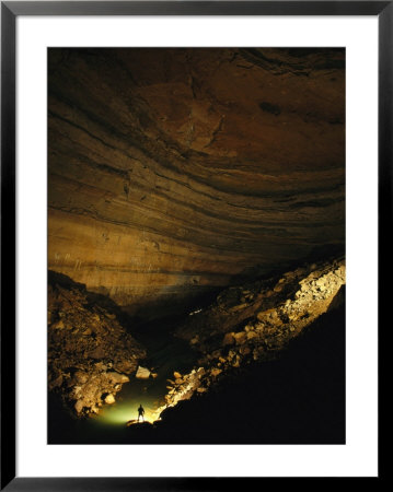 Man Stands In A Cave Chamber In Rumbling Falls Cave System by Stephen Alvarez Pricing Limited Edition Print image