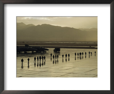 Silhouettes Of Men And Planes On A Military Base Runway by Maria Stenzel Pricing Limited Edition Print image