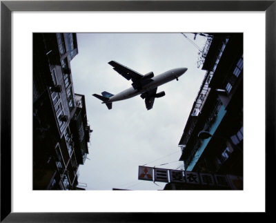 A Jet Soars Above The Crowded Streets Of Hong Kong by Jodi Cobb Pricing Limited Edition Print image