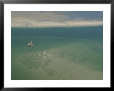 Shrimp Boat Hovers Above Rippled Sand In Wattenmeer National Park by Norbert Rosing Pricing Limited Edition Print image