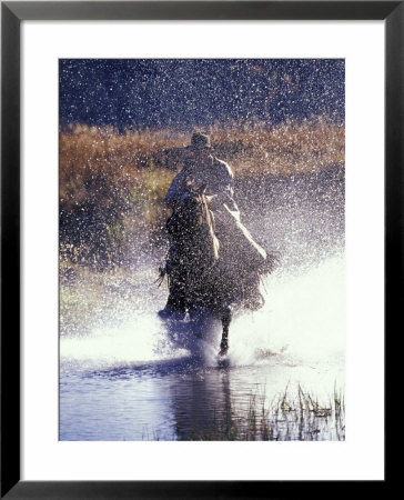 Cowboy On Horseback Galloping Through River, Ponderosa Ranch, Seneca, Oregon, Usa by Darrell Gulin Pricing Limited Edition Print image