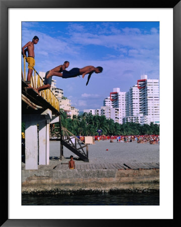 Boys Jumping From Bridge In El Rodadero, Seaside Suburb Of Santa Marta, Colombia by Krzysztof Dydynski Pricing Limited Edition Print image