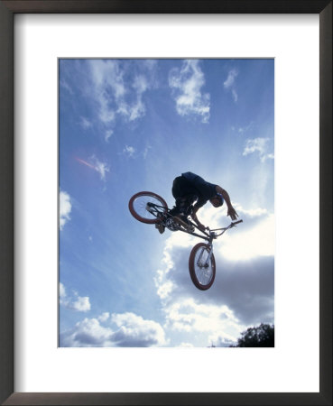Silhouette Of Cyclist Leaping Through The Air by Ted Wilcox Pricing Limited Edition Print image