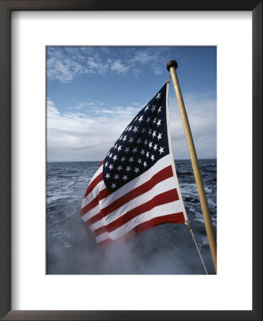 An American Flag Flutters From The Back Of A Boat In Neah Bay by Sam Abell Pricing Limited Edition Print image