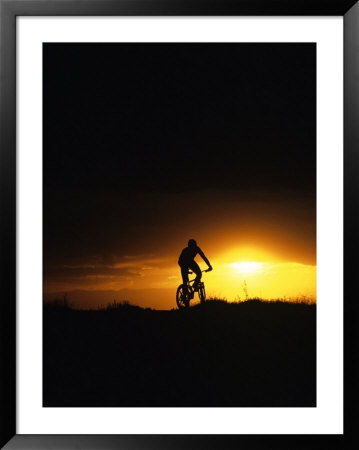 Mountain Biker Against Stormy Sunset, Fruita, Colorado, Usa by Chuck Haney Pricing Limited Edition Print image