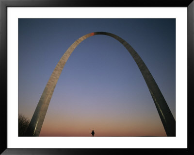 A Lone Person Passes Beneath The Gateway Arch In Saint Louis by Joel Sartore Pricing Limited Edition Print image