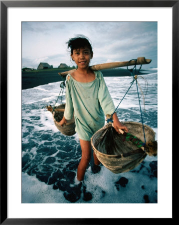 A Girl Gathers Salt Water In Lontar Leaf Buckets For Salt Making, Kusamba, Indonesia by Adams Gregory Pricing Limited Edition Print image