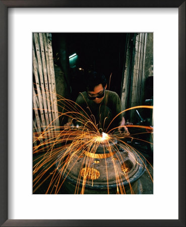 Man Working At Metalworks In Chinatown, Bangkok, Thailand by Bill Wassman Pricing Limited Edition Print image