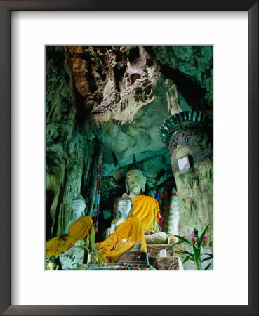 Seated Buddha Statues In Saffron Cloth Inside Cave, Chiang Dao, Thailand by Ryan Fox Pricing Limited Edition Print image