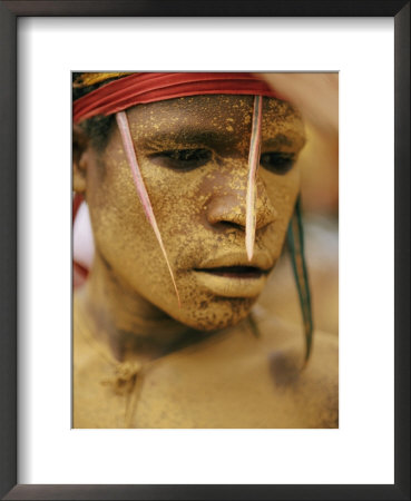Bright Yellow Face Paint And Elaborate Headdress Decorate The Face Of A Tribesman by Jodi Cobb Pricing Limited Edition Print image