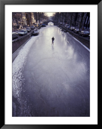 Skater On Frozen Canal, Amsterdam, Netherlands by Michele Molinari Pricing Limited Edition Print image