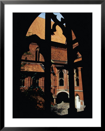 Medieval Window And Courtyard Of The High Castle At Malbork Castle, Malbork, Pomorskie, Poland by Krzysztof Dydynski Pricing Limited Edition Print image