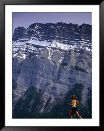 Woman Running In Front Of Mountain, Banff, Canada by Woods Wheatcroft Pricing Limited Edition Print image