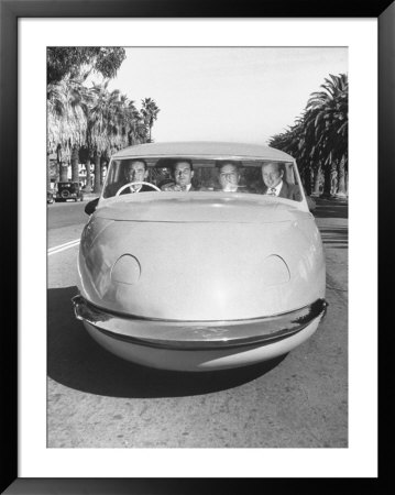 Four Men Driving Down Street In Davis Motorcar Three Wheeled Car by Allan Grant Pricing Limited Edition Print image