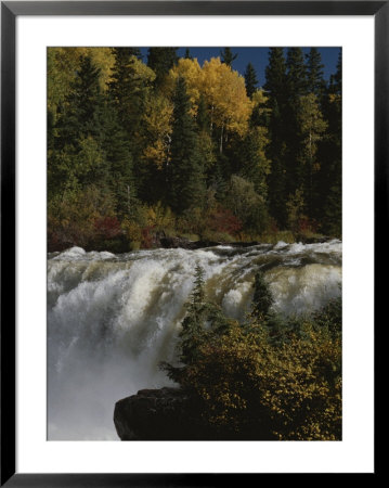 A Waterfall Cascades Past Forests, Bright With Autumn Foliage by Raymond Gehman Pricing Limited Edition Print image