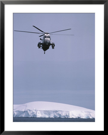 An Argentine Helicopter Flies Over Anvers Island by Gordon Wiltsie Pricing Limited Edition Print image