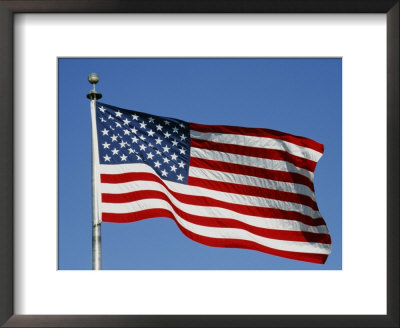 American Flag Blowing Against A Blue Sky On The Grounds Of The Washington Monument by Stephen St. John Pricing Limited Edition Print image