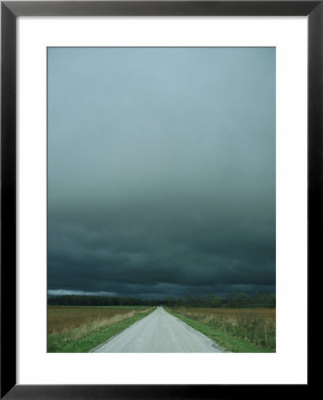 Spring Storm Blows In Across A Gravel Road by Stephen Alvarez Pricing Limited Edition Print image